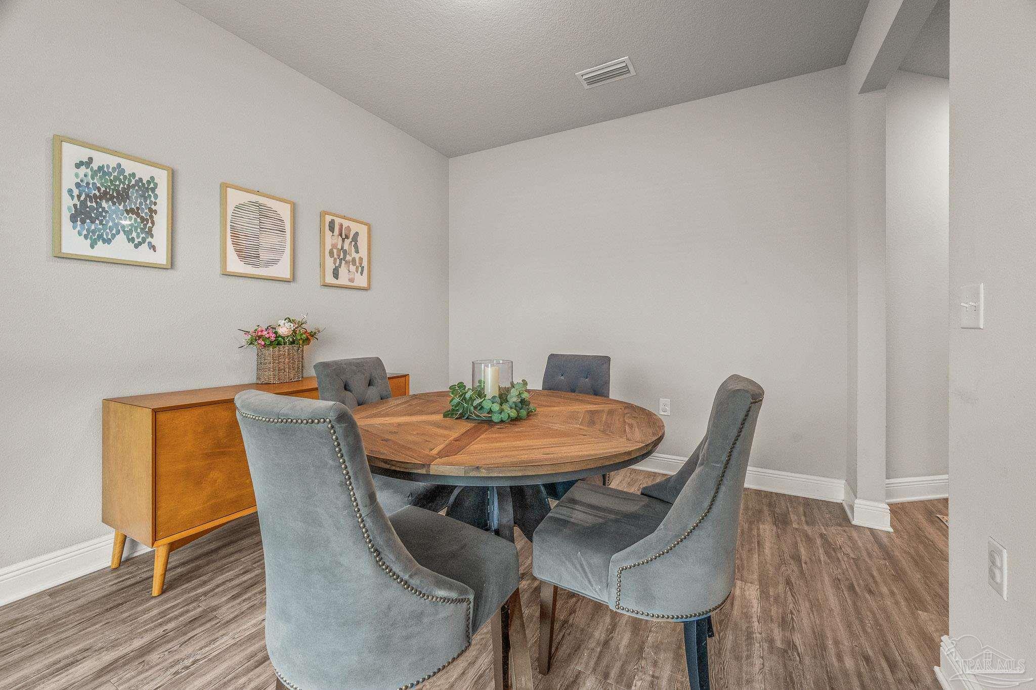 5329 Talon Road Pace, FL 32571 - Photo 20 of 45 a view of a dining room with furniture and wooden floor