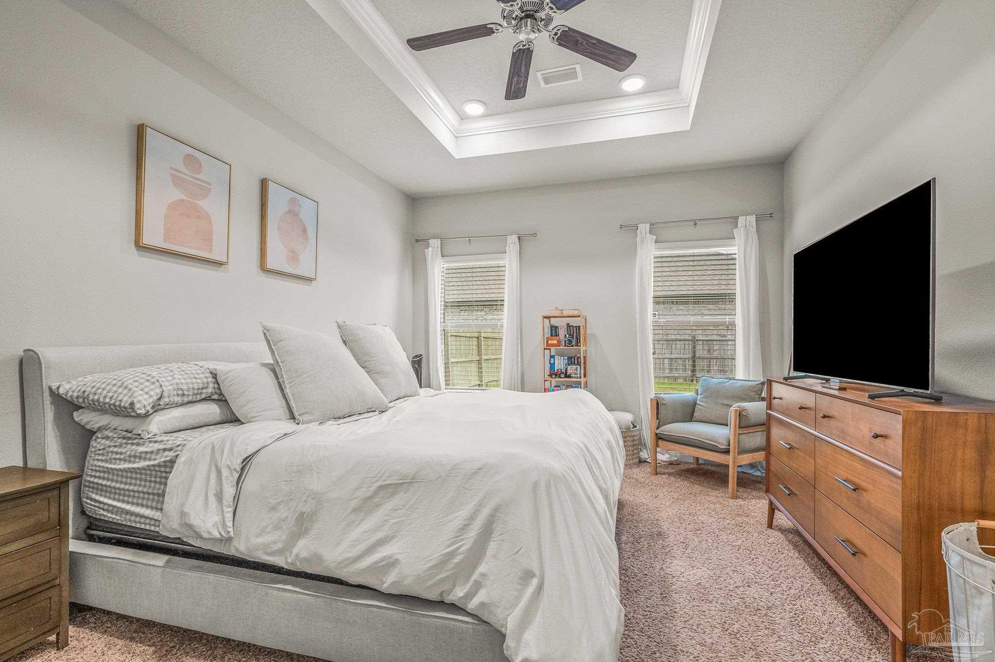 5329 Talon Road Pace, FL 32571 - Photo 21 of 45 a bedroom with a bed and a flat screen tv