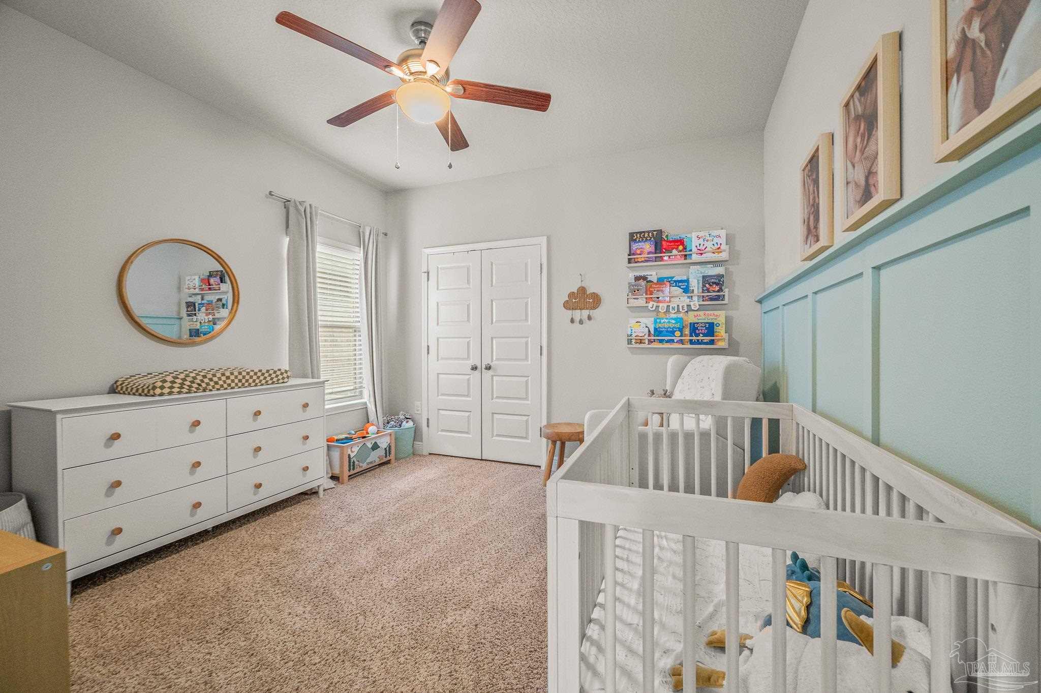 5329 Talon Road Pace, FL 32571 - Photo 31 of 45 a bedroom with furniture and a baby crib