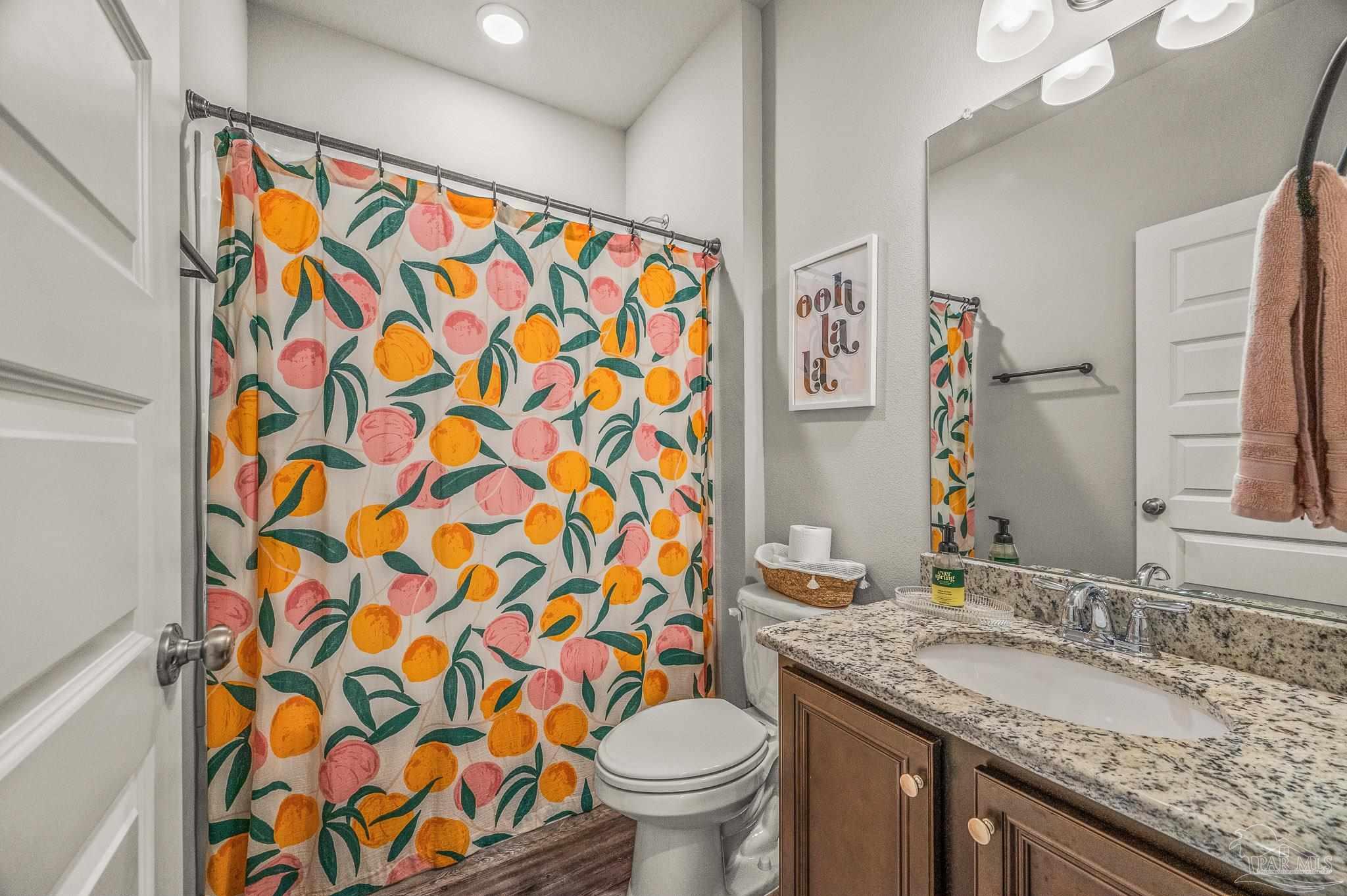 5329 Talon Road Pace, FL 32571 - Photo 35 of 45 a bathroom with a granite countertop sink a toilet and a mirror