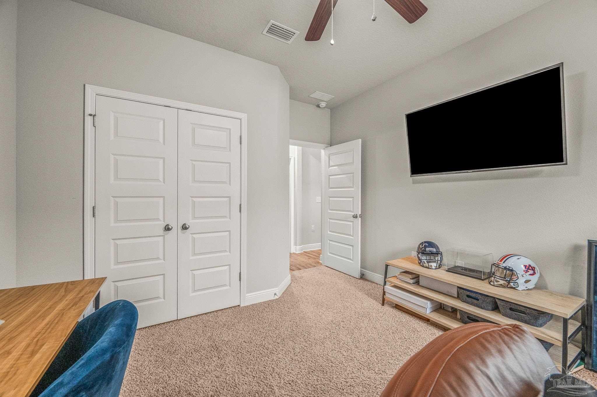 5329 Talon Road Pace, FL 32571 - Photo 38 of 45 a bedroom with a bed and a flat screen tv