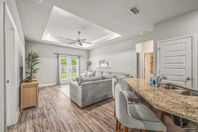 a living room with granite countertop furniture and wooden floor