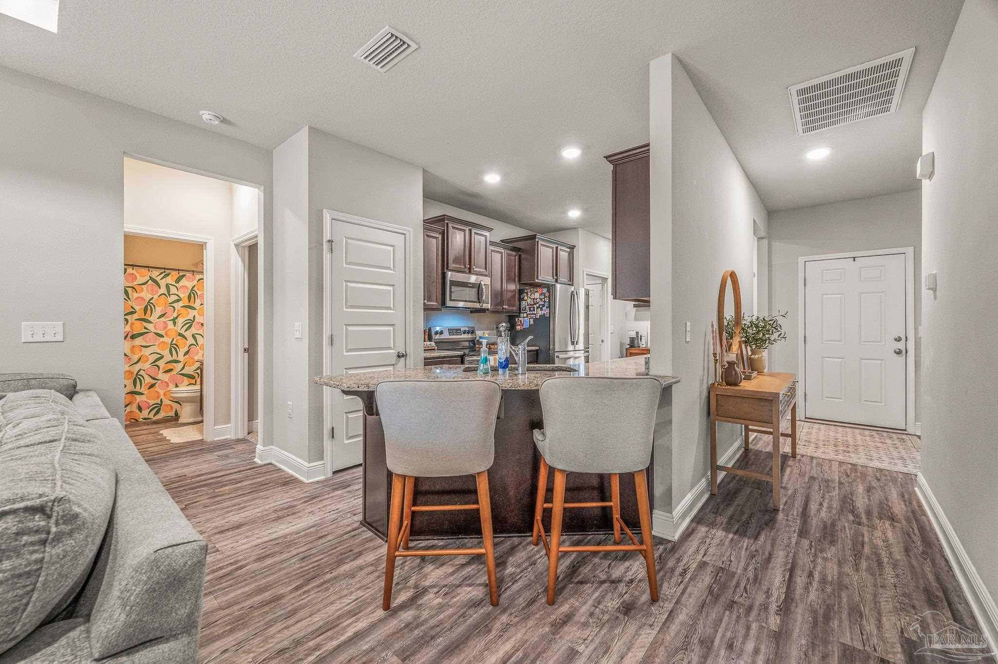 5329 Talon Road Pace, FL 32571 - Photo 7 of 45 a view of a dining room with furniture and wooden floor