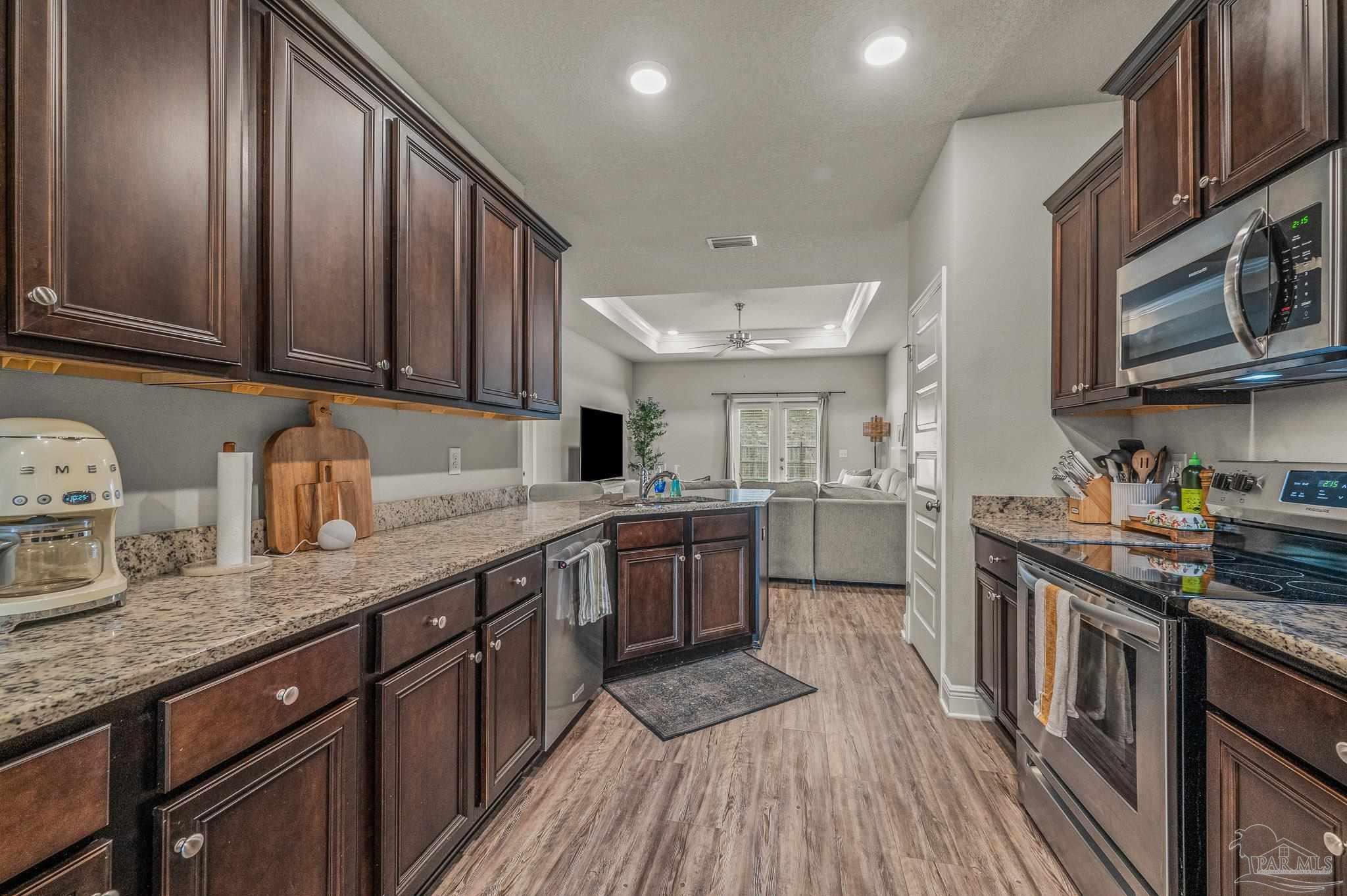 5329 Talon Road Pace, FL 32571 - Photo 8 of 45 a kitchen with stainless steel appliances granite countertop wooden cabinets a sink dishwasher a stove and a refrigerator