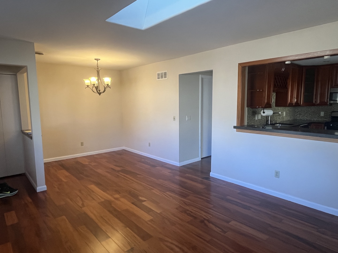 1748 Brookdale Road Naperville, IL 60563 - Photo 12 of 28 an empty room with wooden floor and a bathroom