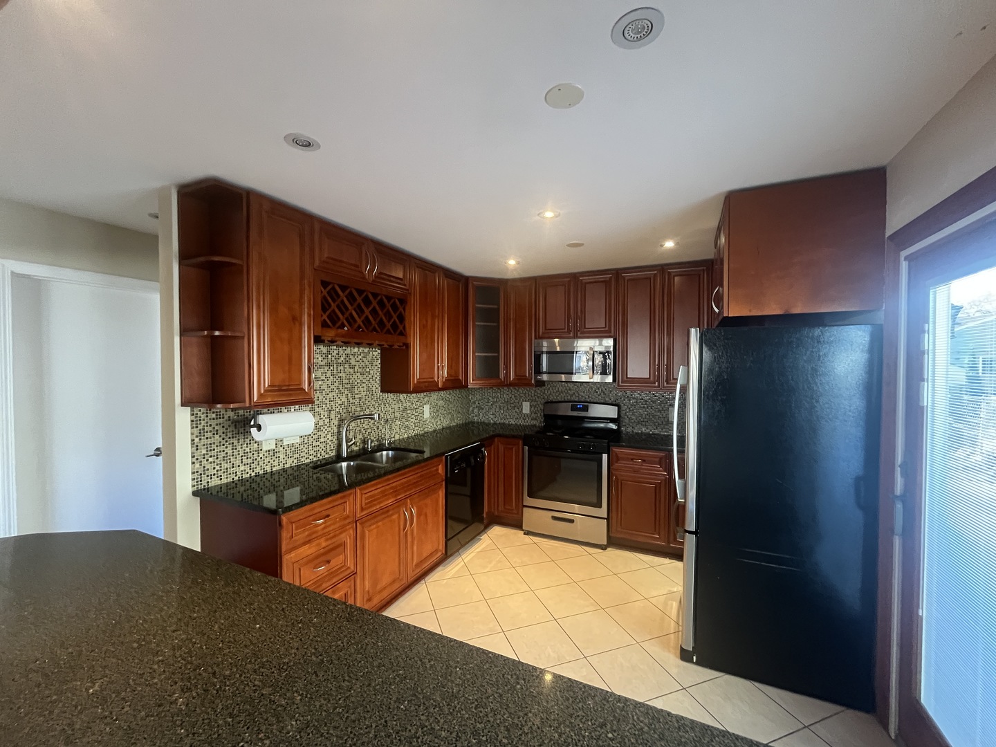 1748 Brookdale Road Naperville, IL 60563 - Photo 14 of 28 a kitchen with stainless steel appliances granite countertop a refrigerator stove top oven and sink