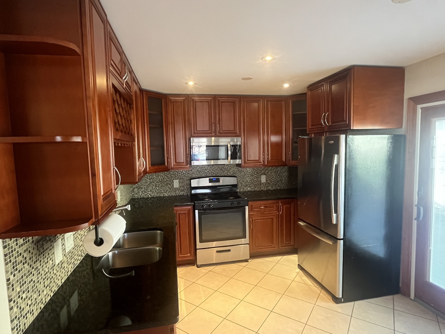 1748 Brookdale Road Naperville, IL 60563 - Photo 15 of 28 a kitchen with stainless steel appliances granite countertop a refrigerator stove and cabinets