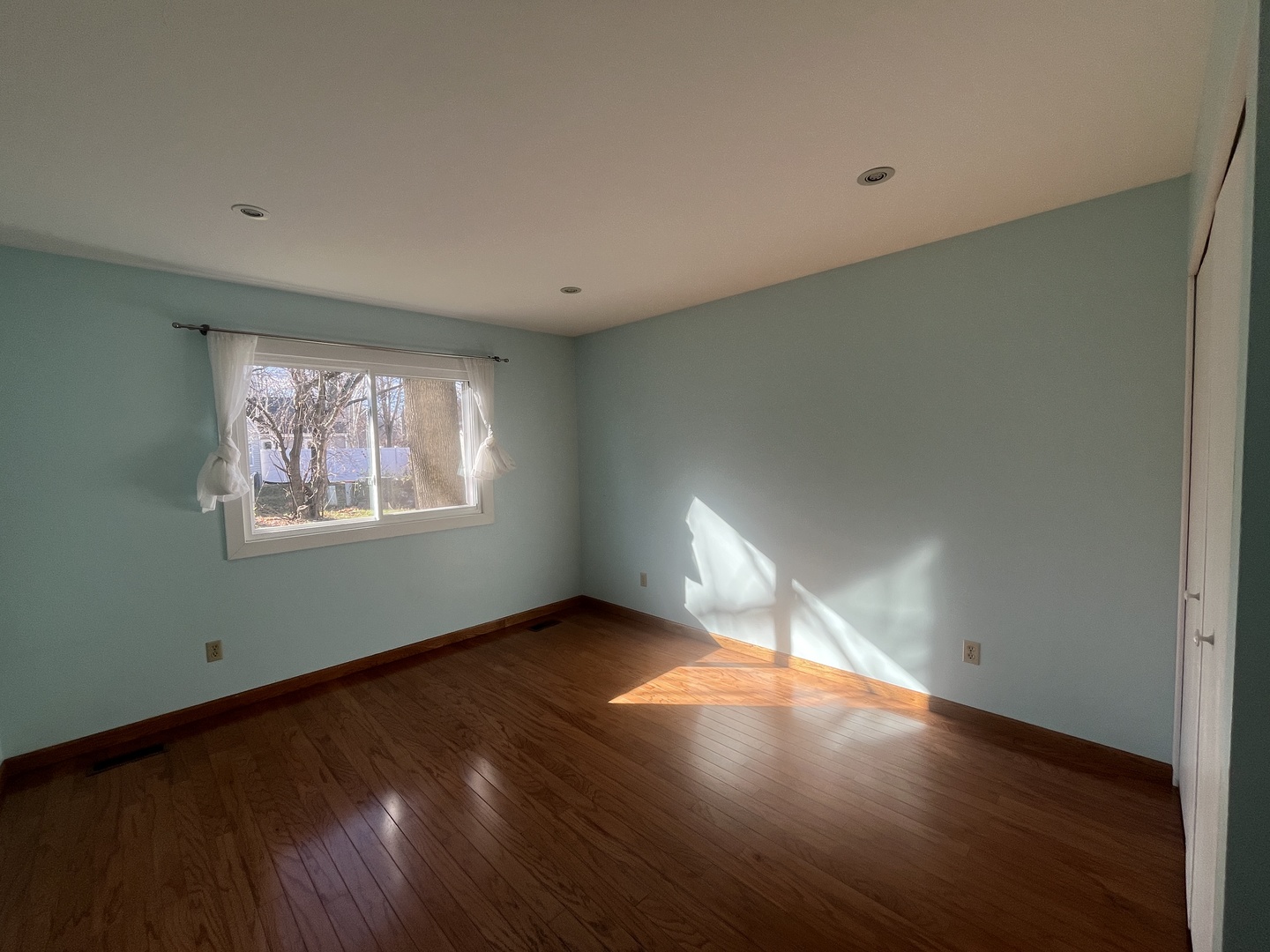 1748 Brookdale Road Naperville, IL 60563 - Photo 19 of 28 a view of an empty room with wooden floor and a window