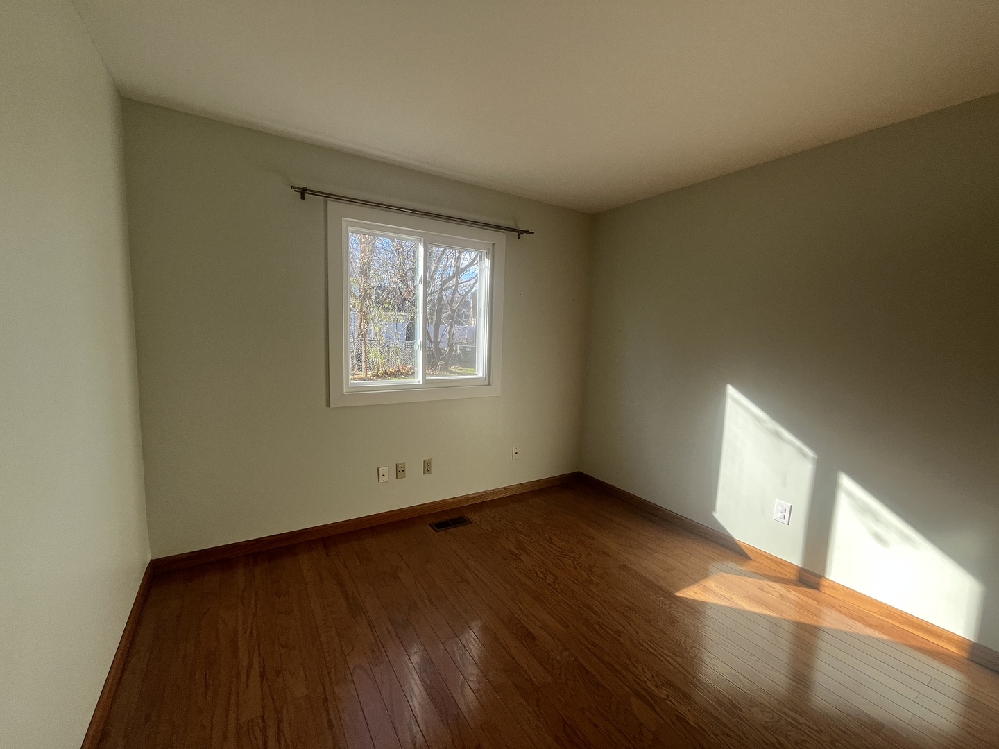 1748 Brookdale Road Naperville, IL 60563 - Photo 20 of 28 an empty room with wooden floor and windows
