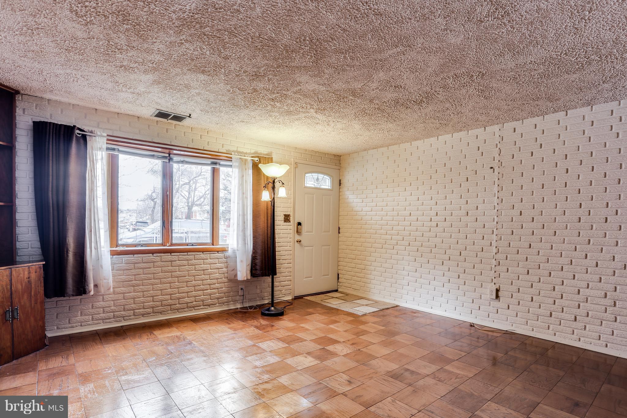 2701 Yarnall Road Baltimore, MD 21227 - Photo 3 of 27 Living Room with Large Bay Window and Hardwoods