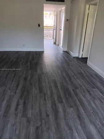 a view of a livingroom with wooden floor