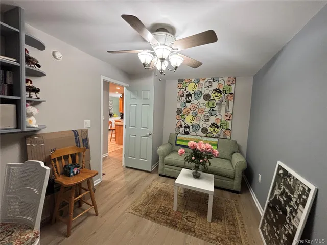 a view of a house with a yard and large tree