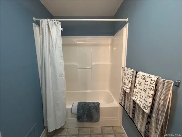 a front view of a house with a garden and deck