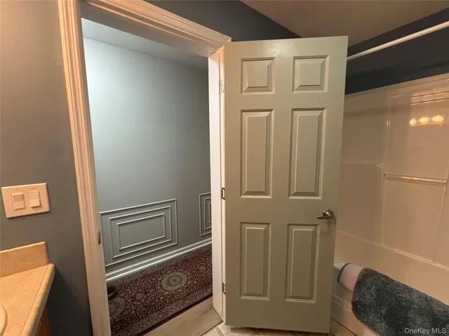 a view of a house with backyard and white fence