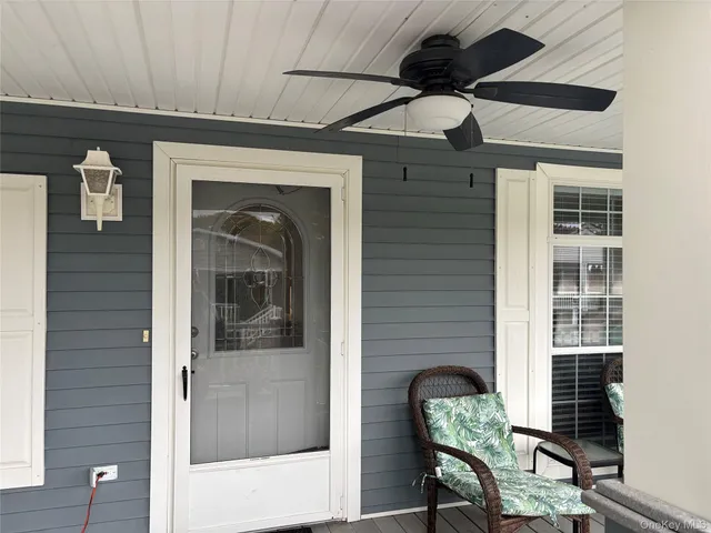 a kitchen with granite countertop kitchen island stainless steel appliances a stove a sink a refrigerator cabinets and a dining table with wooden floor