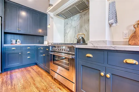 a bedroom with a bed a mirror on dresser and a window