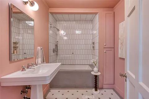 a bedroom with a large bed and wooden floor