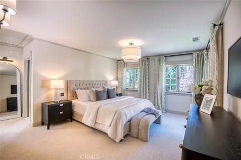 a bedroom with a bed and a lamp