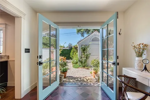 a view of a house with backyard sitting area and garden