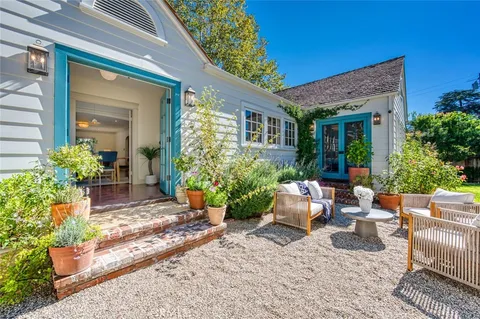 a backyard of a house with outdoor seating
