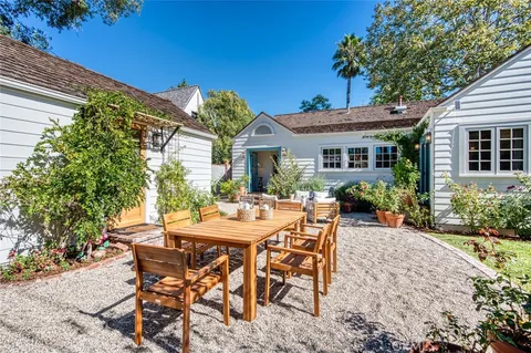 a front view of a house with a yard table and chairs