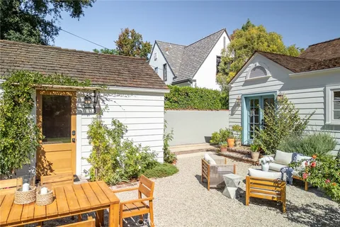 a view of a house with backyard and sitting area