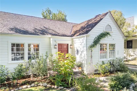 a view of a house with potted plants