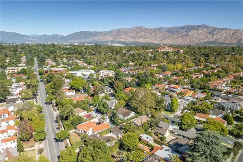 an aerial view of residential houses with city view