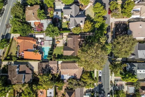 a view of a lush green field with mountains in the background