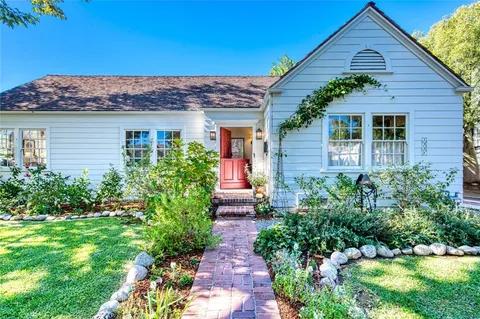 a front view of a house with garden