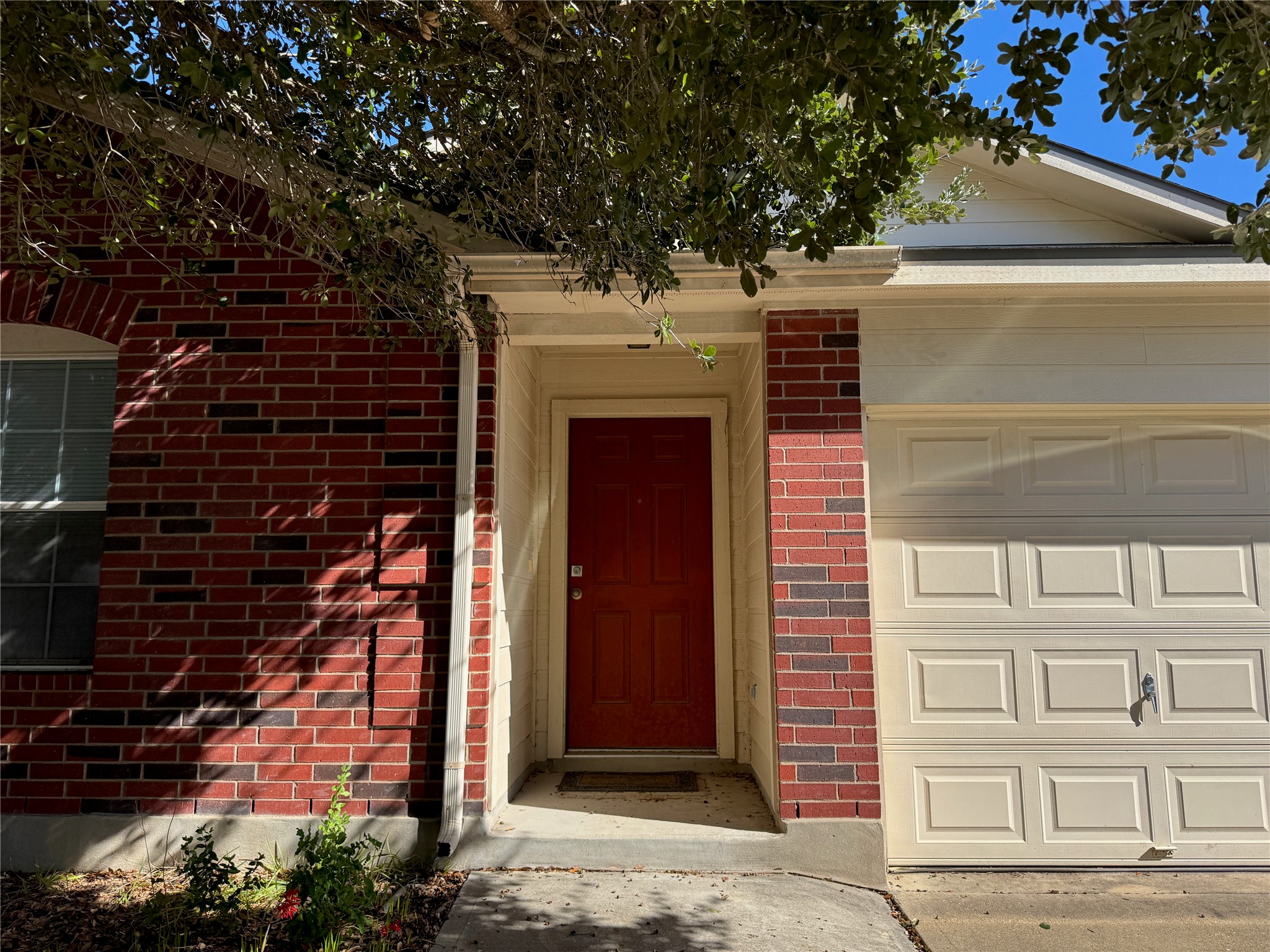 18420 Wind Tree Lane Elgin, TX 78621 - Photo 1 of 15 a front view of a house with a garden