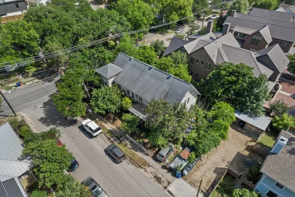 an aerial view of multiple houses with yard