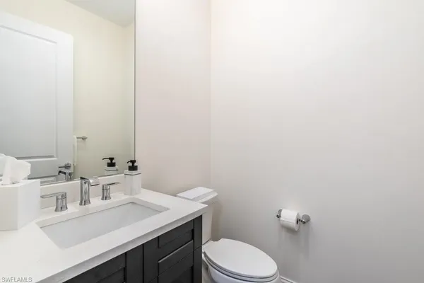 a bathroom with a sink a toilet and mirror