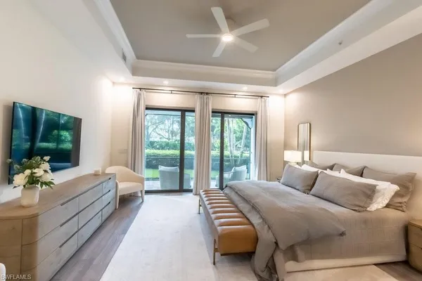 a room with a bed and large window