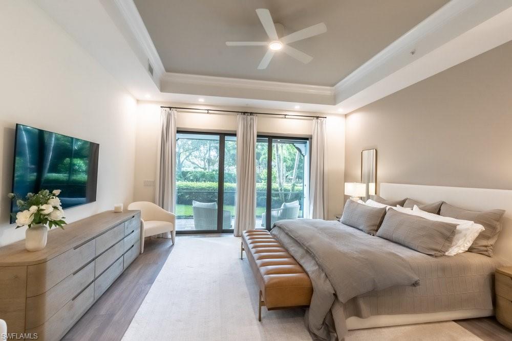 16394 Corsica Way, Unit 101 Naples, FL 34110 - Photo 15 of 43 a room with a bed and large window