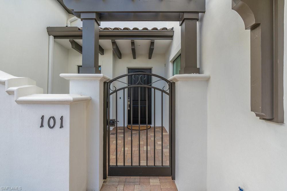 16394 Corsica Way, Unit 101 Naples, FL 34110 - Photo 2 of 43 a view of a entryway door of the house