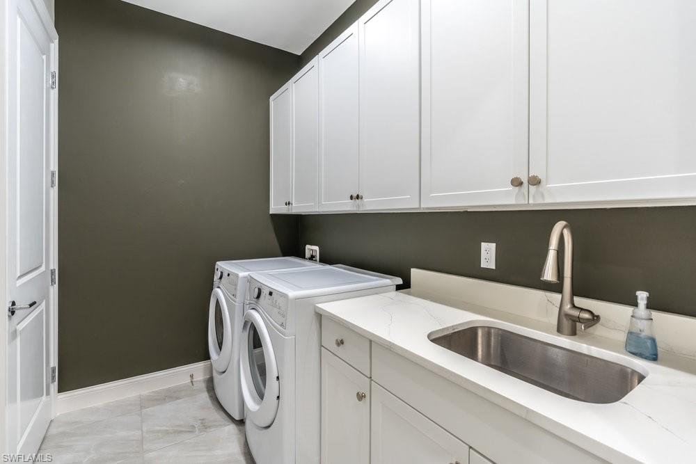 16394 Corsica Way, Unit 101 Naples, FL 34110 - Photo 25 of 43 a utility room with dryer and washer