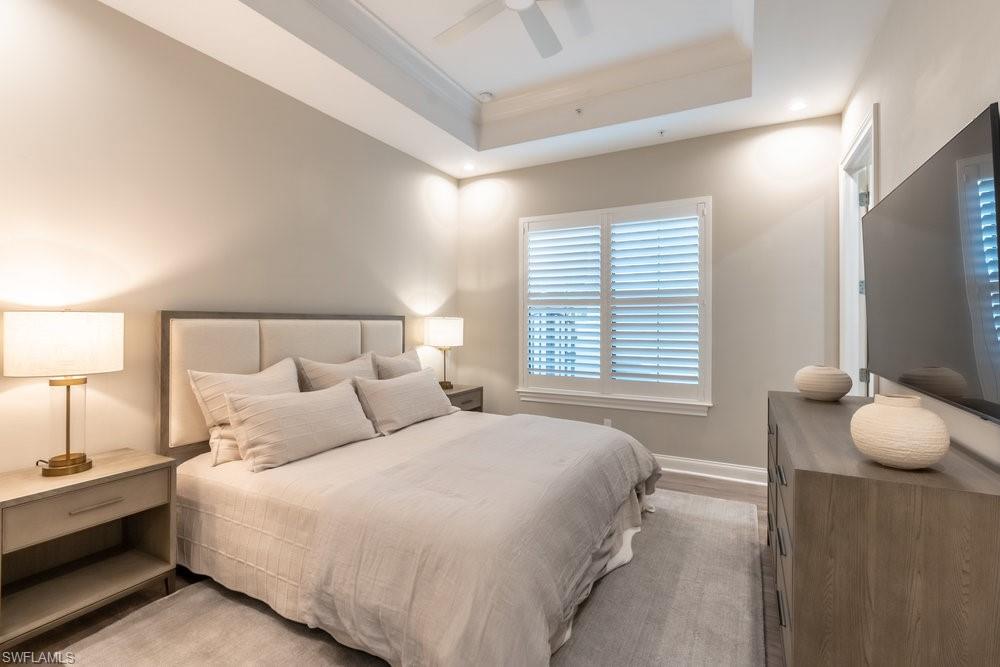 16394 Corsica Way, Unit 101 Naples, FL 34110 - Photo 26 of 43 a bedroom with a bed and window