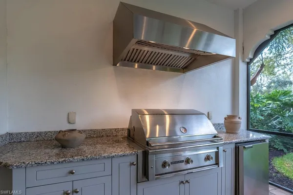 a kitchen with a stove a sink and cabinets