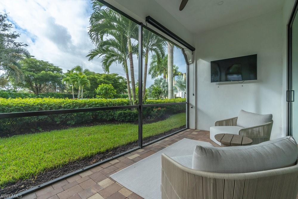 16394 Corsica Way, Unit 101 Naples, FL 34110 - Photo 35 of 43 a balcony with furniture and garden