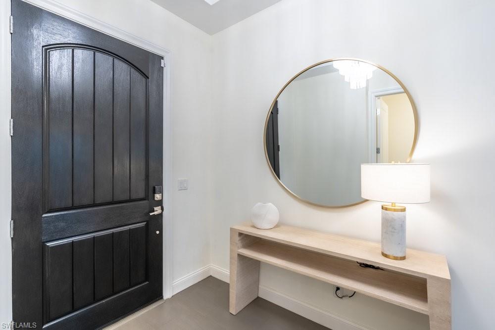 16394 Corsica Way, Unit 101 Naples, FL 34110 - Photo 4 of 43 a close view of light fixtures and wood floor