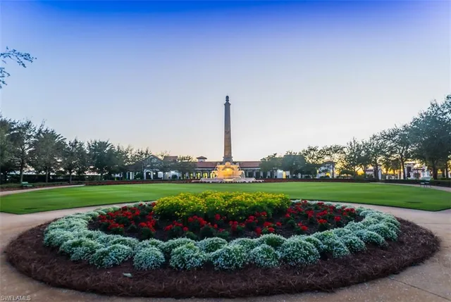 a view of a garden with a big and white house