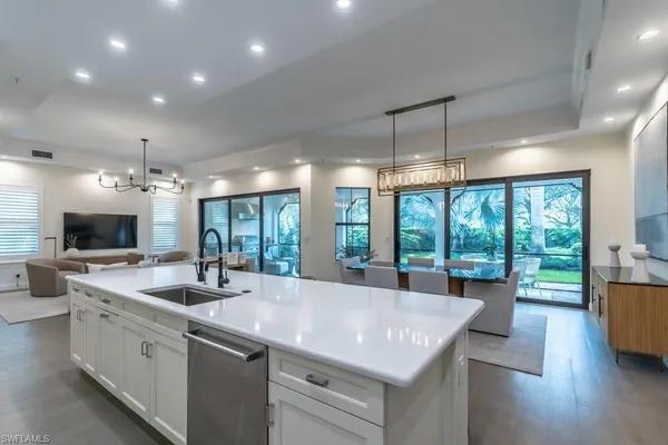 a kitchen with sink stove and cabinets