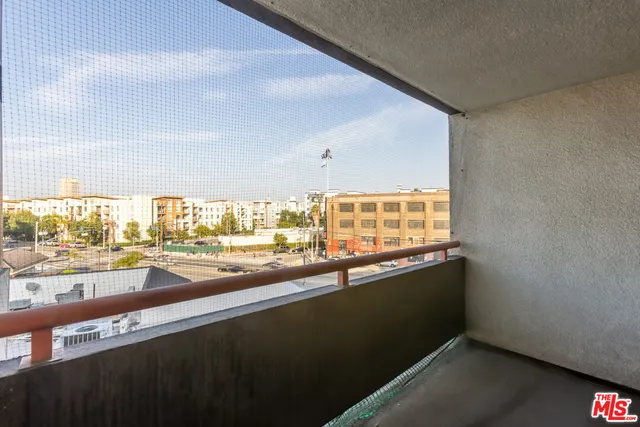 a kitchen with a sink and large windows
