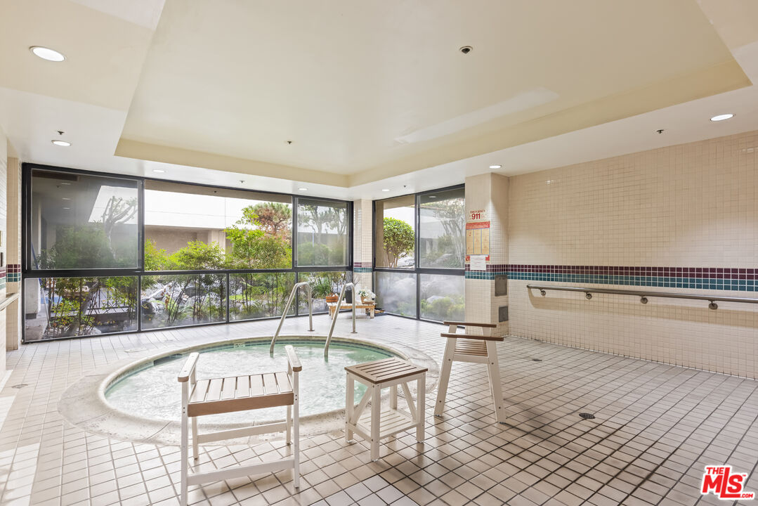 222 South Central Avenue, Unit 315 Los Angeles, CA 90012 - Photo 20 of 22 a living room with a large window and a table