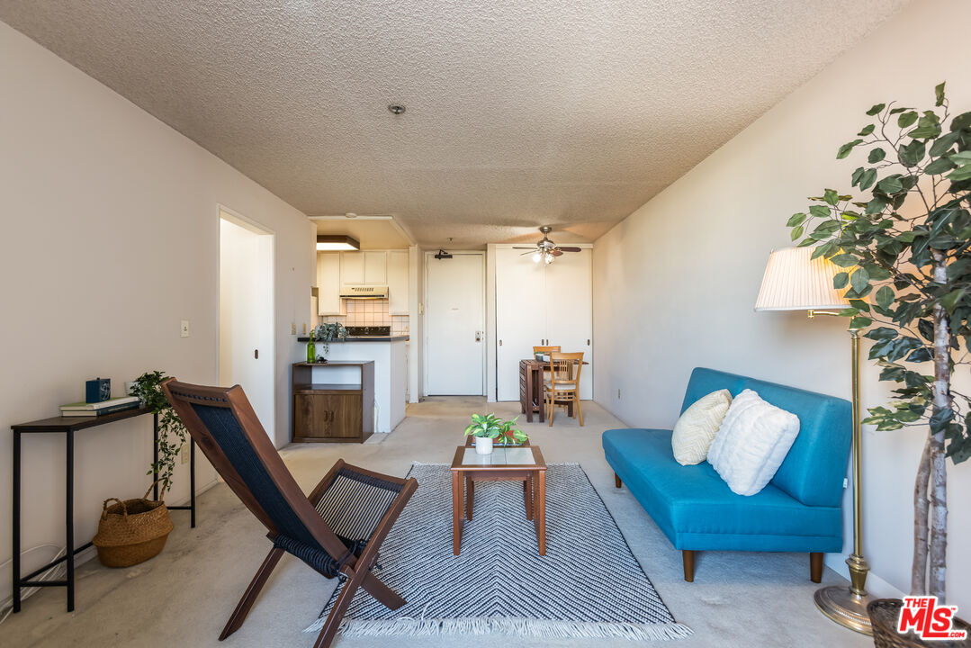 222 South Central Avenue, Unit 315 Los Angeles, CA 90012 - Photo 5 of 22 a living room with furniture and a chandelier