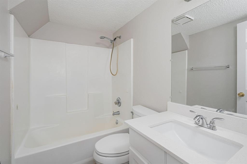 900 South Tennessee Street, Unit 13 McKinney, TX 75069 - Photo 11 of 16 a bathroom with a sink toilet and shower