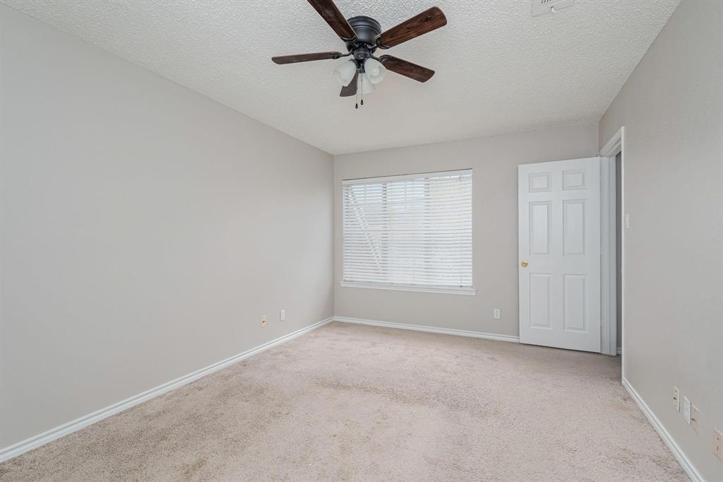 900 South Tennessee Street, Unit 13 McKinney, TX 75069 - Photo 12 of 16 wooden floor in an empty room with a window