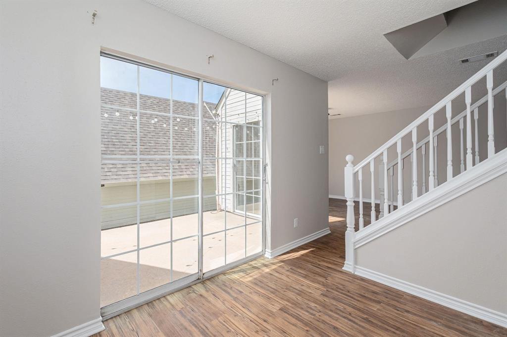 900 South Tennessee Street, Unit 13 McKinney, TX 75069 - Photo 2 of 16 a view of an empty room with wooden floor and windows