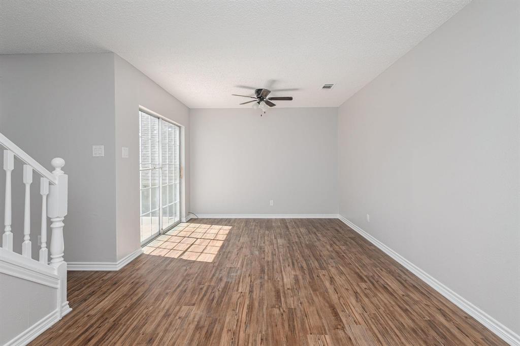 900 South Tennessee Street, Unit 13 McKinney, TX 75069 - Photo 5 of 16 wooden floor in an empty room with a window